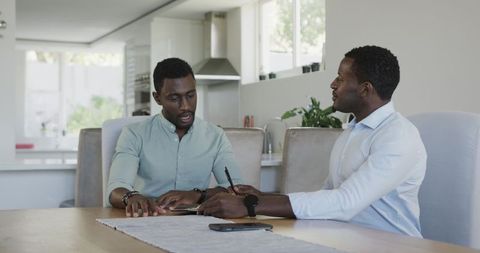 Two Friends Chatting and Laughing Over Coffee Indoors