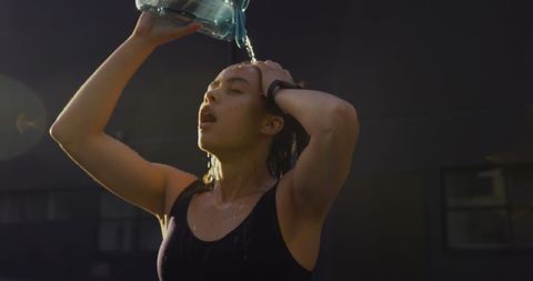 Young Woman Pouring Water in Urban Setting