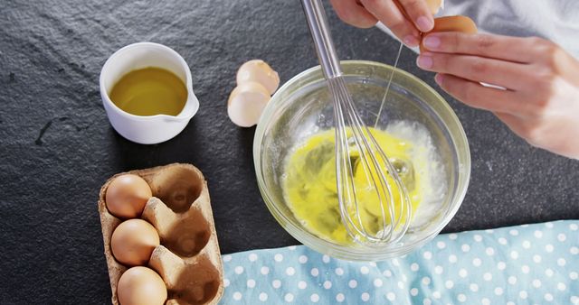 Hands cracking eggs into bowl with whisk for baking - Download Free Stock Images Pikwizard.com