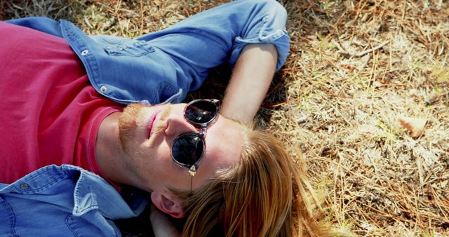 Man in sunglasses laying on the grass 