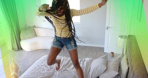 Playful Woman in Bedroom Jumping on Bed with Cat