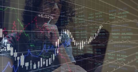 Male Financial Analyst Studying Candlestick Charts and Market Data on Office Monitor