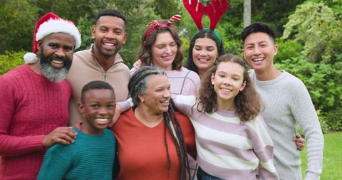 Diverse Family Celebrating Christmas Outdoors in Festive Attire