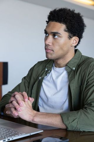 Focused Professional Using Laptop for Modern Office Task