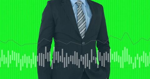 Businessman standing with waveform and financial line graph over green chroma background