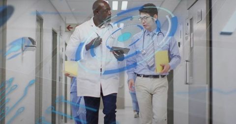 Doctors walking and discussing digital health data using tablet and holographic interface