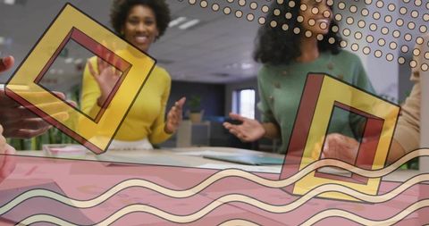 Creative team collaborating with colorful geometric overlays in modern open office