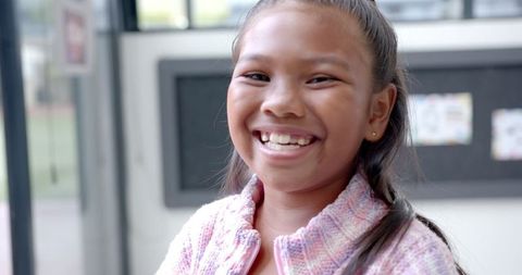 Smiling Girl in Classroom Embracing Learning