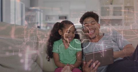 Father and daughter sharing secure tablet time with digital privacy and cybersecurity