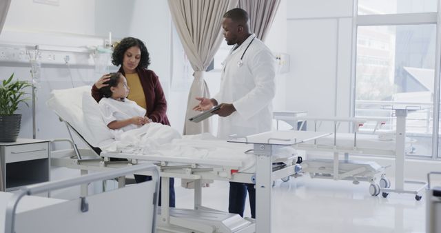 Concerned Mother with Doctor and Child in Hospital Room - Download Free Stock Images Pikwizard.com