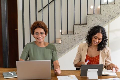 Diverse Professional Women Collaborating in Modern Office Environment