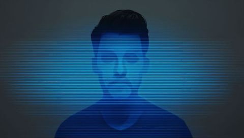 Hispanic man posing behind blue horizontal scanline glitch for cyber identity concept