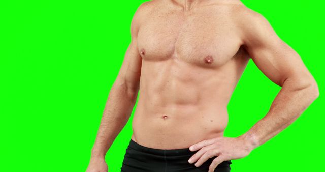 This image showcases a muscular, shirtless man posing against a green screen background. Perfect for use in fitness, health, and bodybuilding promotions, or as a visual aid in fitness-related video content and advertising.