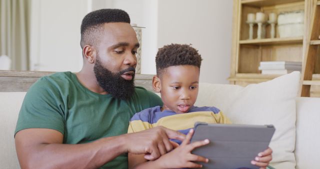 Father and Son Bonding Over Tablet on Sofa - Download Free Stock Images Pikwizard.com