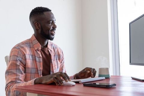 Focused Professional Working on Computer at Home Office Desk