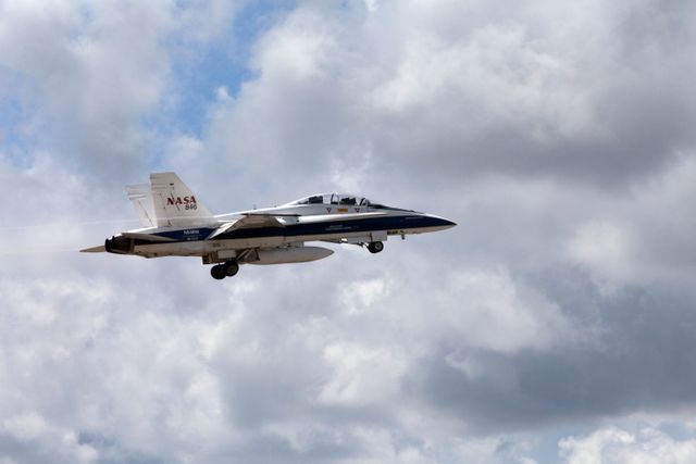 NASA's F-18 jet is conducting flights at the Shuttle Landing Facility at Kennedy Space Center in Florida to study sonic boom effects. Flights in August 2017 aim to measure low-altitude turbulence. The Sonic Booms in Atmospheric Turbulence (SonicBAT II) Program involves collaboration with Armstrong Flight Research Center, Langley Research Center, and Space Florida. This content is ideal for educational use in aerospace studies, scientific articles on supersonic flight, and material promoting aerospace research initiatives.