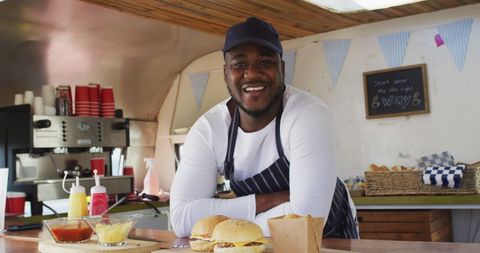 Smiling Chef in Food Truck Serving Burgers - Download Free Stock Images Pikwizard.com