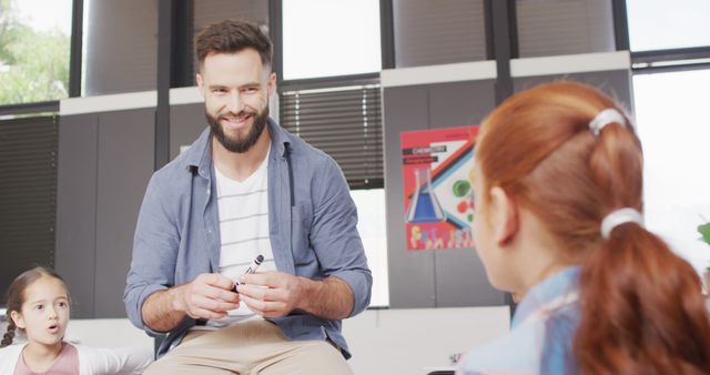 Smiling Teacher Engaging with Students in Classroom - Download Free Stock Images Pikwizard.com