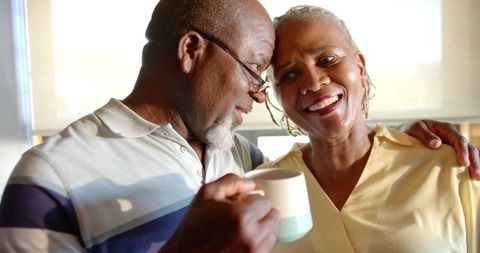 Senior Couple Embracing in Sunlit Kitchen - Download Free Stock Images Pikwizard.com