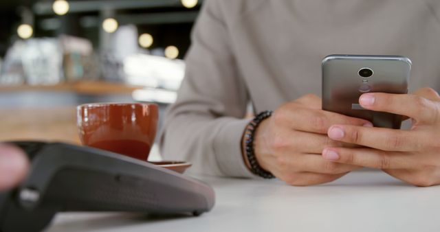 Person Using Smartphone for Contactless Payment in Cozy Cafe - Download Free Stock Images Pikwizard.com