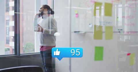 Businessman Engaged in Mobile Call in Modern Office with Sticky Notes