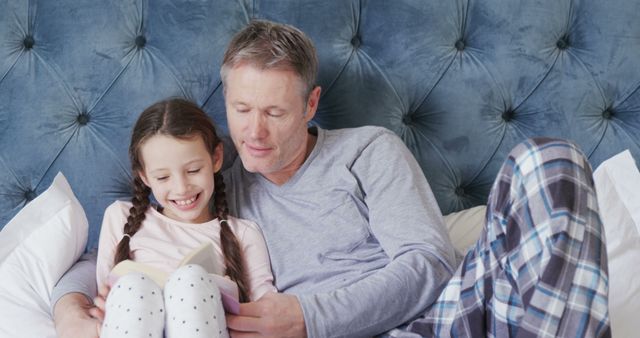 Father and Daughter Reading Book Together in Bed - Download Free Stock Images Pikwizard.com