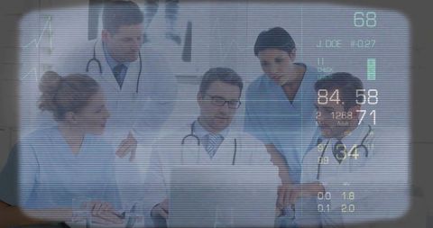 Multidisciplinary medical team reviewing patient vitals on laptop with futuristic hud overlay