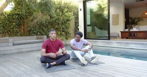 Friends Exercising on Deck Using Fitness Trackers