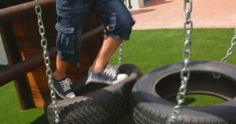 Boys Feet Balancing on Tire Playground Apparatus Plus Action - Download Free Stock Images Pikwizard.com