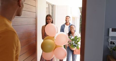 Diverse Group Welcoming Friends with Gifts