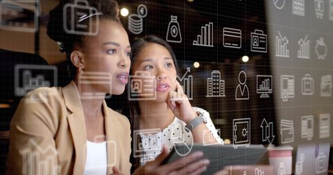 Diverse Businesswomen Analyzing Data with Digital Overlay
