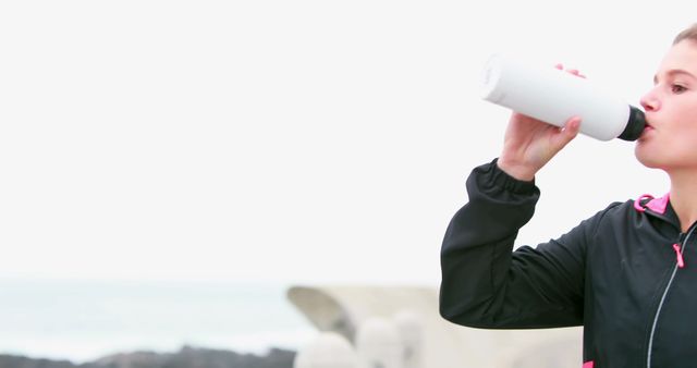 Woman Drinking Water from Bottle While Exercising Outdoors - Download Free Stock Images Pikwizard.com