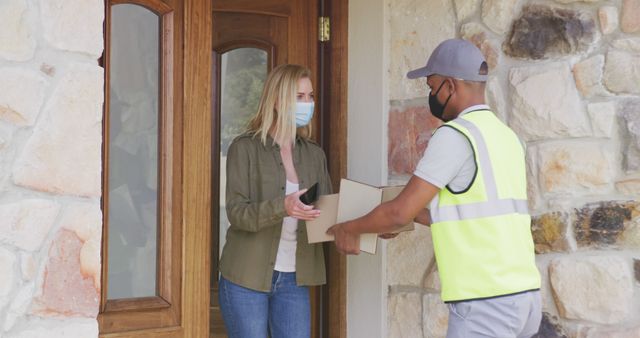 Delivery Driver Handing Over Package to Woman at Front Door - Download Free Stock Images Pikwizard.com