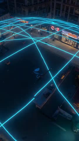 Vertical drone video tracing neon cyan light web over urban plaza at night with people in coats