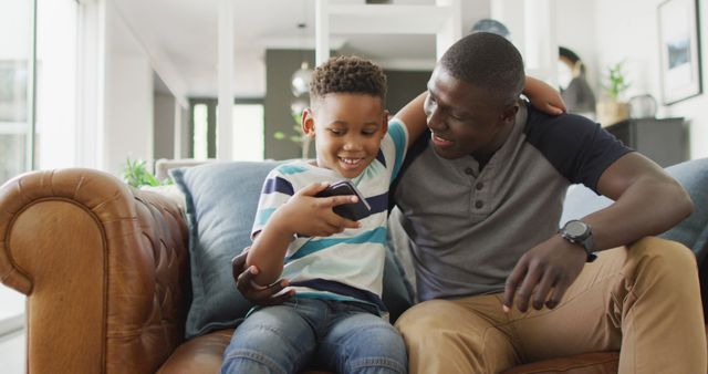 Father and Son Bonding at Home While Using Smartphone - Download Free Stock Images Pikwizard.com