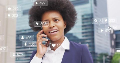 Black businesswoman talking on smartphone downtown with social media notifications overlay