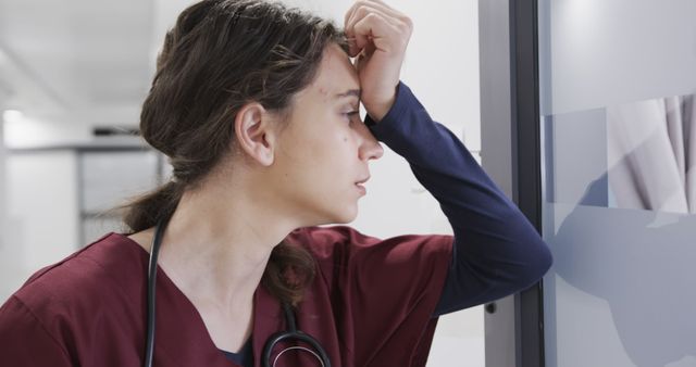 Stressed Nurse Taking Break in Hospital Corridor - Download Free Stock Images Pikwizard.com