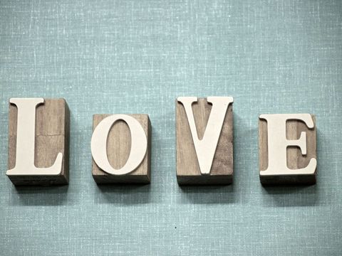 Wooden love letters on blue linen background