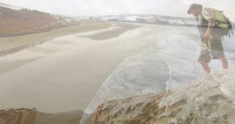 Male Hiker Overlooking Expansive Beachscape Adventure