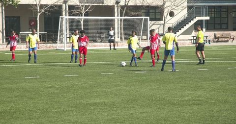 Youth soccer players competing on sunny day