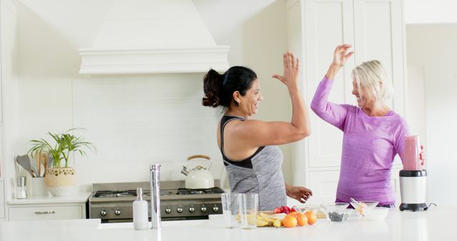 Two Happy Women Celebrating Healthy Cooking in Kitchen - Download Free Stock Images Pikwizard.com