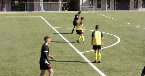 Determined Soccer Players Focused on Match Tactics