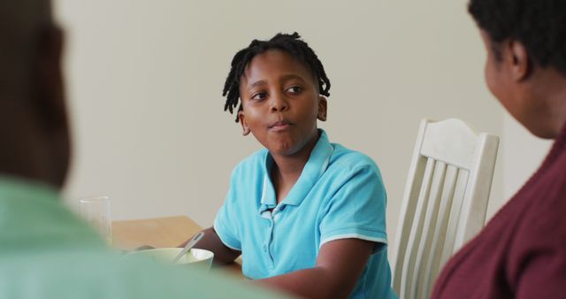 Smiling African American boy having family meal - Download Free Stock Images Pikwizard.com