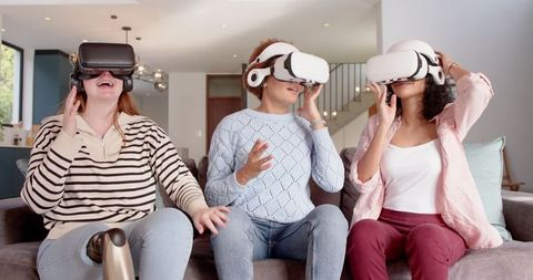 Diverse Friends Enjoying Virtual Reality Technology at Home