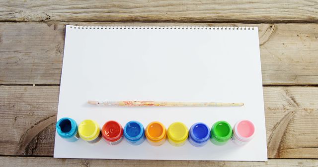 Blank Sheet with Colorful Paint Pots and Brush on Wooden Table - Download Free Stock Images Pikwizard.com