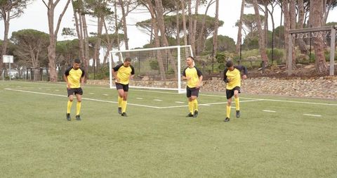 Soccer Players Stretching and Preparing on the Field