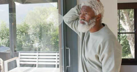 Senior African American Man in Thought by Glass Door
