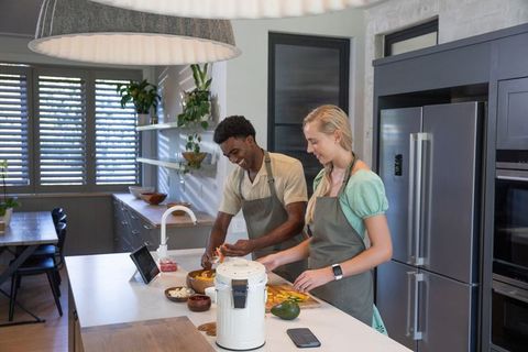 Couple Collaborating in Modern Kitchen Preparing Fresh Meal