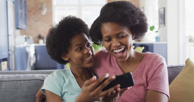 Mother and Daughter Laughing Together at Home with Smartphone - Download Free Stock Images Pikwizard.com