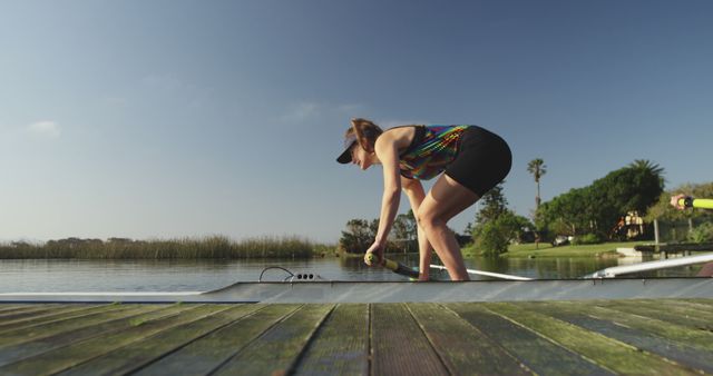 Female Rower Preparing to Launch Boat on Lake - Download Free Stock Images Pikwizard.com